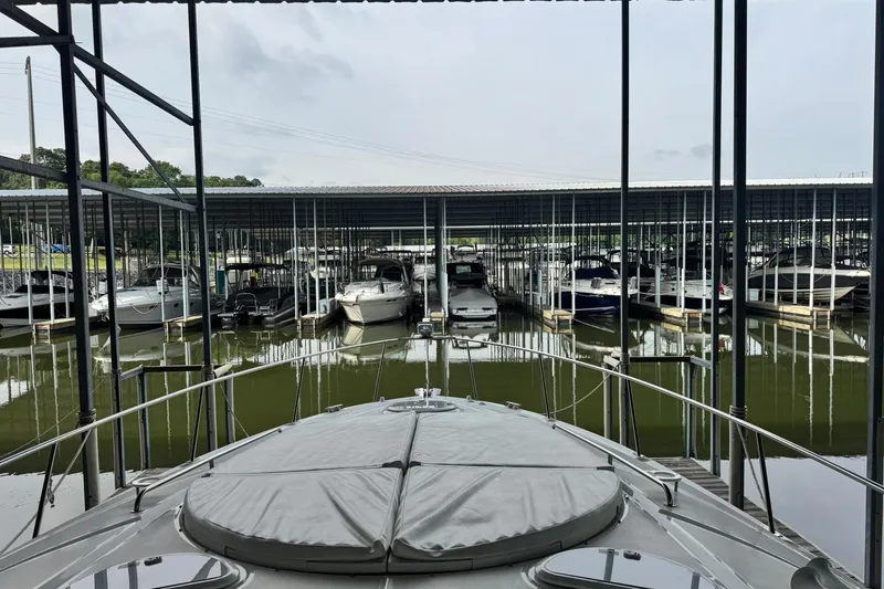 Slide: The Image of 2015 Cruisers Yachts 380 Express docked in a marina with multiple boats. - 4