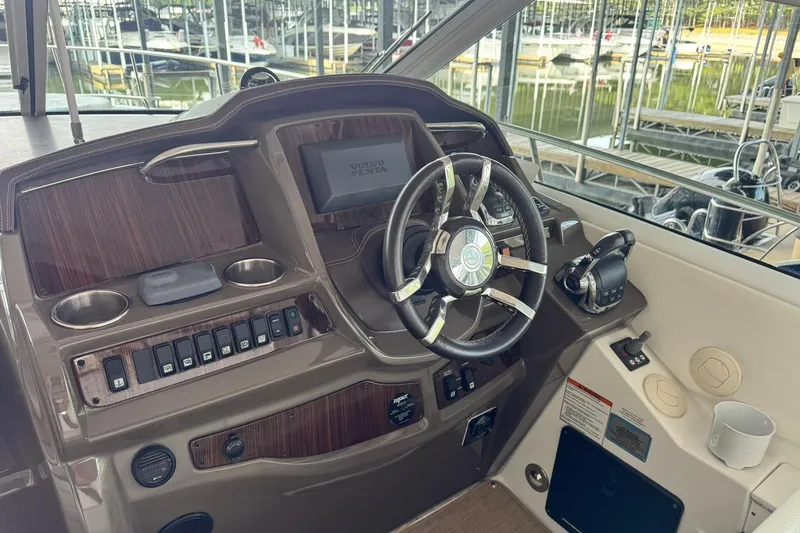 Slide: The Image of Helm of 2015 Cruisers Yachts 380 Express with steering wheel and controls. - 5