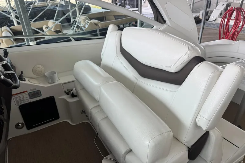 Slide: The Image of 2015 Cruisers Yachts 380 Express interior with white leather seating and helm station. - 6