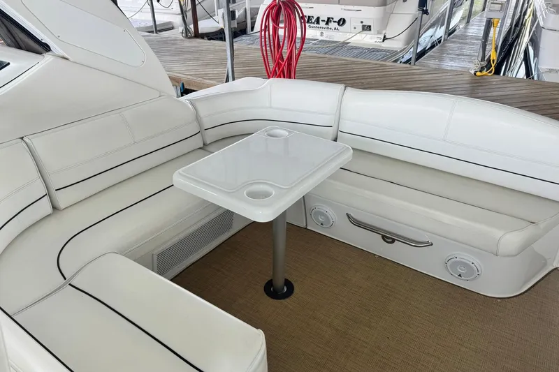Slide: The Image of Interior seating area of 2015 Cruisers Yachts 380 Express with white upholstery and table. - 7