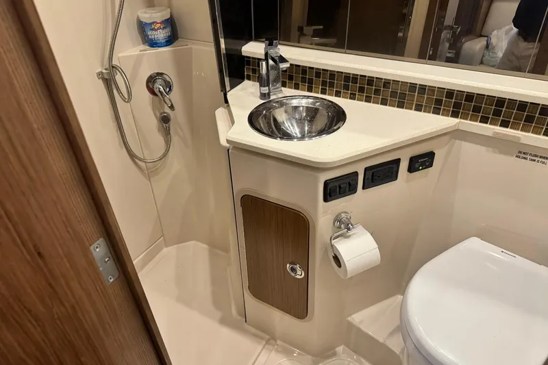 Slide: The Image of 2015 Cruisers Yachts 380 Express bathroom with sink, shower, and toilet. - 8