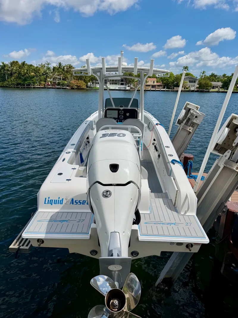Slide: The Image of 2019 Concept 27 boat at dock with outboard motor. - 1