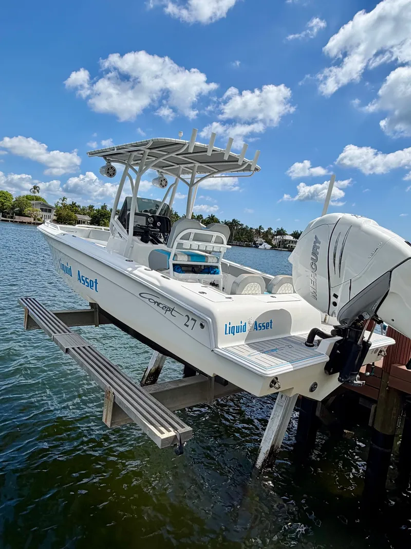 Slide: The Image of 2019 Concept 27 boat on a lift by the water. - 10