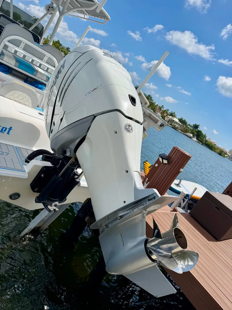 Slide: The Image of 2019 Concept 27 boat with outboard motor at dock. - 2