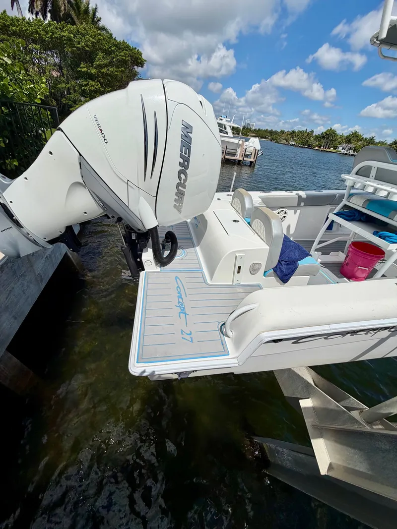 Slide: The Image of 2019 Concept 27 boat with Mercury outboard motor by the water. - 5