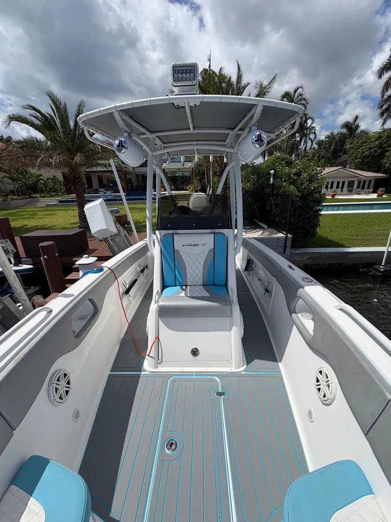Slide: The Image of Interior view of a 2019 Concept 27 boat with blue and white seating. - 7