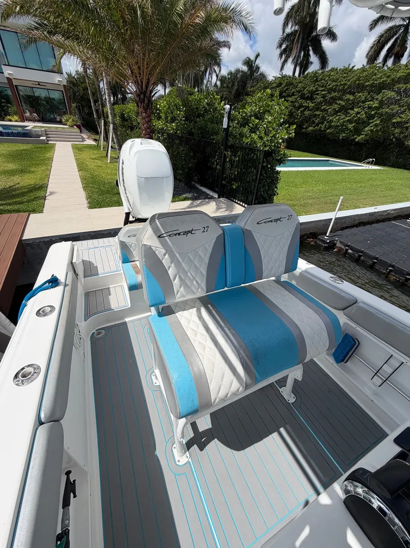 Slide: The Image of 2019 Concept 27 boat with blue and gray seating outdoors. - 8