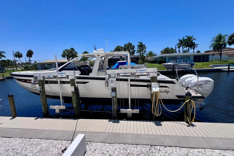 Slide: The Image of 2022 Windy SR 44 BLACKHAWK yacht docked, featuring sleek design and powerful engines. - 11