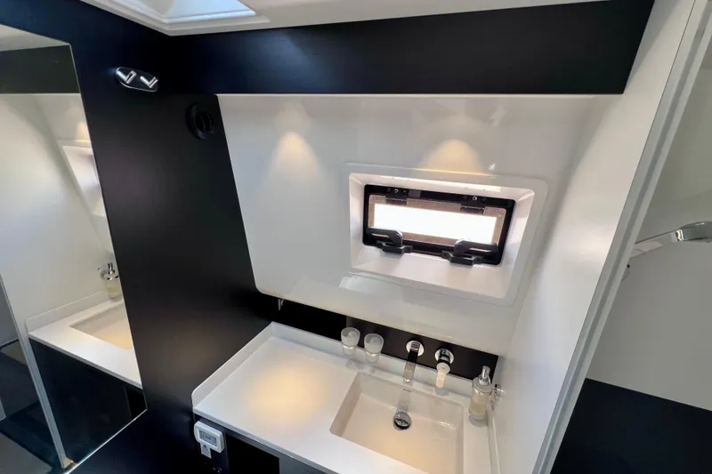 Slide: The Image of Modern bathroom interior of 2022 Windy SR 44 BLACKHAWK yacht with sleek sink and window. - 110