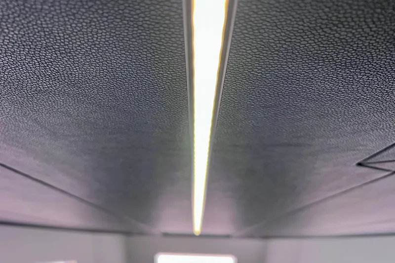 Slide: The Image of Interior ceiling detail of 2022 Windy SR 44 BLACKHAWK with textured finish and sleek lighting. - 112