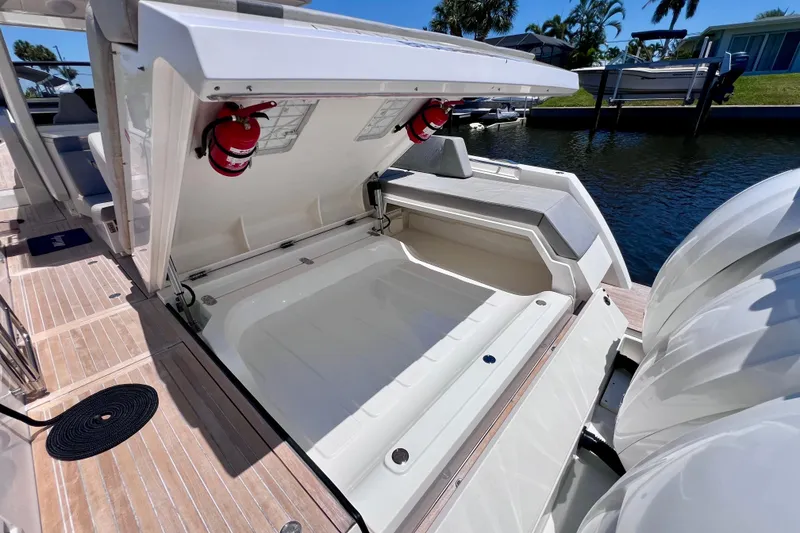 Slide: The Image of 2022 Windy SR 44 BLACKHAWK boat with open storage compartment and fire extinguishers. - 117