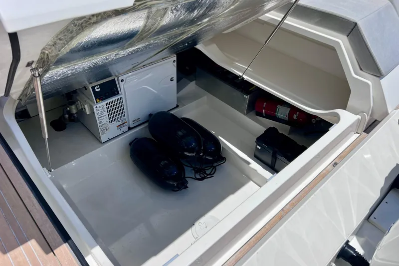 Slide: The Image of Open storage compartment of 2022 Windy SR 44 BLACKHAWK boat with equipment and fire extinguisher. - 118