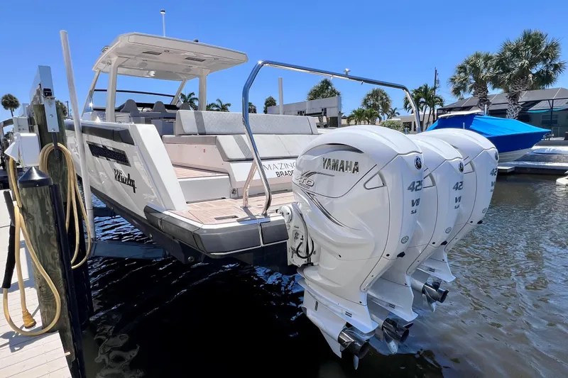 Slide: The Image of 2022 Windy SR 44 BLACKHAWK boat with triple Yamaha 425 engines docked in marina. - 12