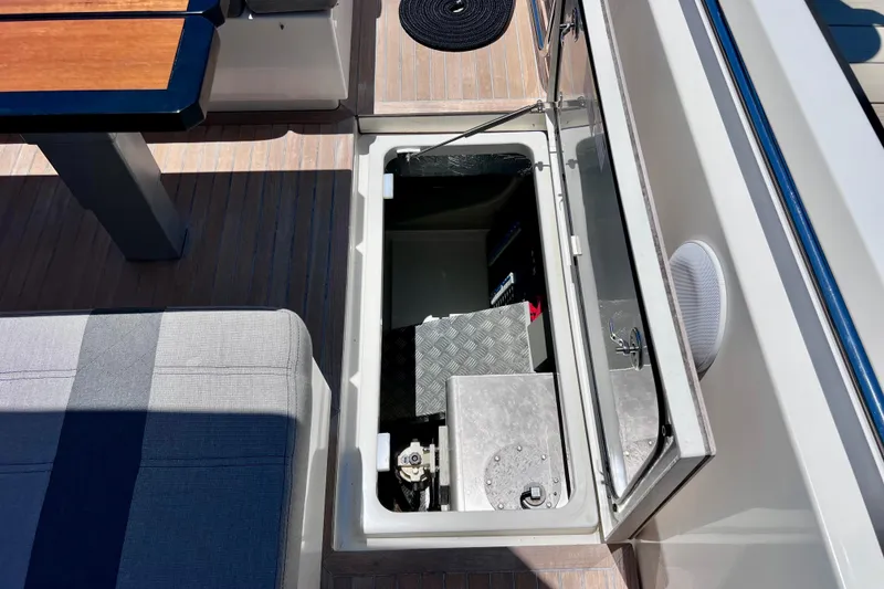 Slide: The Image of Open storage compartment on 2022 Windy SR 44 BLACKHAWK yacht deck, featuring seating and table. - 127