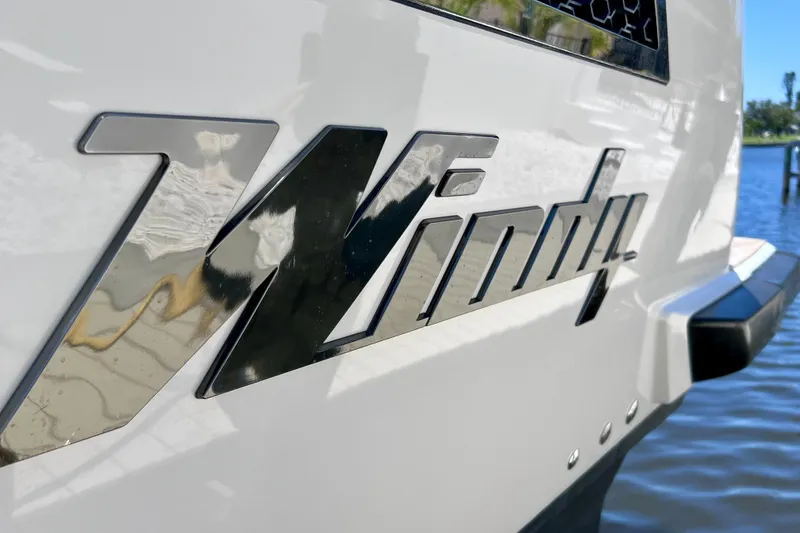 Slide: The Image of Close-up of 2022 Windy SR 44 BLACKHAWK logo on a sleek white boat. - 14