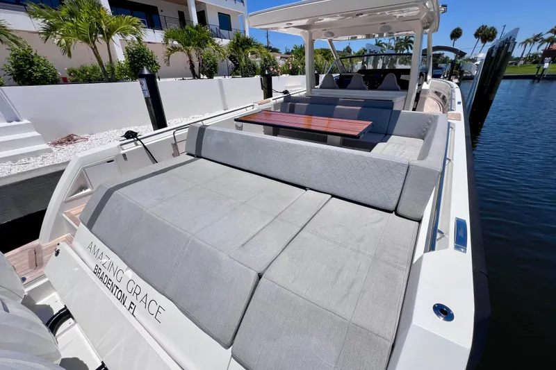 Slide: The Image of 2022 Windy SR 44 BLACKHAWK luxury yacht with spacious seating and elegant design docked by palm trees. - 19