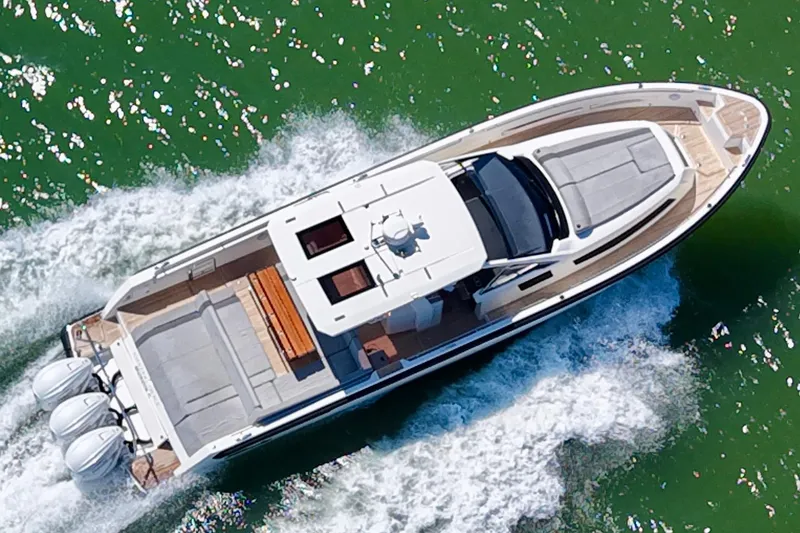 Slide: The Image of Aerial view of 2022 Windy SR 44 BLACKHAWK yacht cruising on green water. - 2