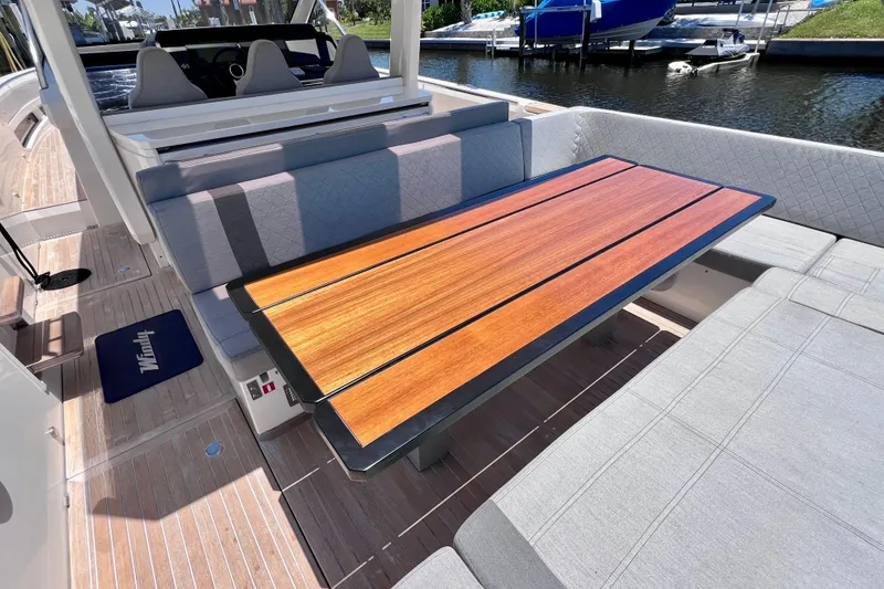 Slide: The Image of Luxurious seating area on 2022 Windy SR 44 BLACKHAWK yacht with wooden table. - 22