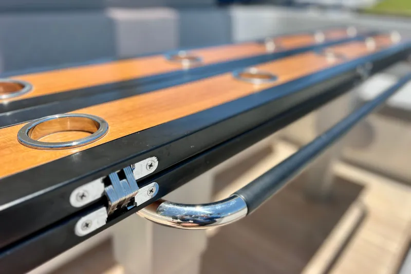 Slide: The Image of Close-up of 2022 Windy SR 44 BLACKHAWK boat's sleek wooden and metal detailing. - 23