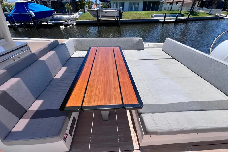 Slide: The Image of Luxury seating area on 2022 Windy SR 44 BLACKHAWK yacht, featuring elegant wooden table. - 25