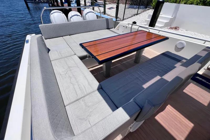 Slide: The Image of Luxurious seating area on 2022 Windy SR 44 BLACKHAWK yacht with elegant wooden table. - 26