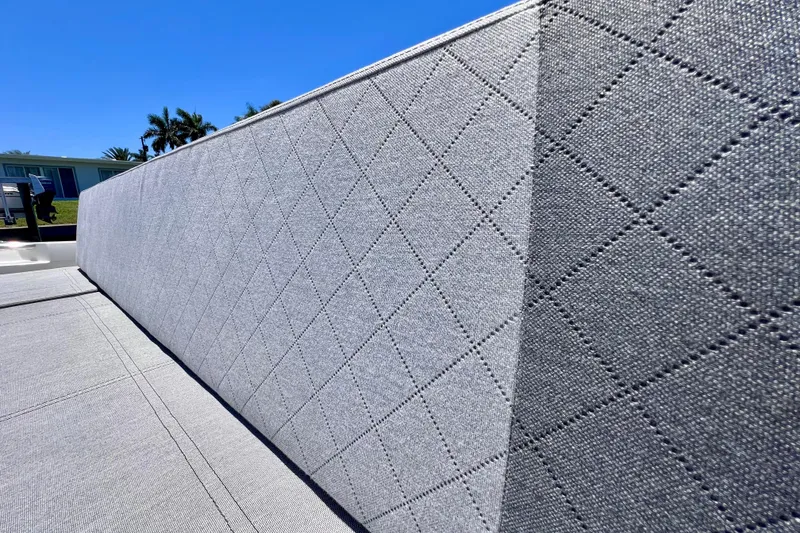 Slide: The Image of Quilted upholstery detail on 2022 Windy SR 44 BLACKHAWK boat under clear blue sky. - 29