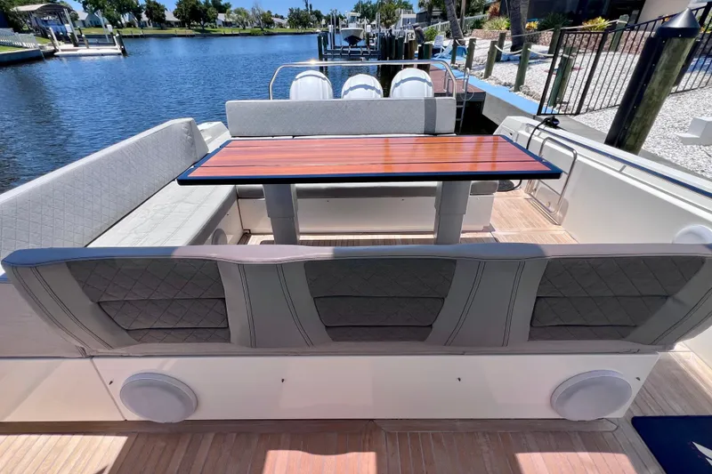 Slide: The Image of Luxury seating area on 2022 Windy SR 44 BLACKHAWK yacht by the water. - 32