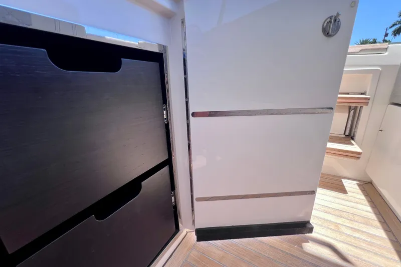 Slide: The Image of Interior view of 2022 Windy SR 44 BLACKHAWK yacht, featuring sleek cabinetry and wooden flooring. - 43
