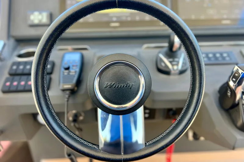 Slide: The Image of Steering wheel of 2022 Windy SR 44 BLACKHAWK boat, featuring modern controls and dashboard. - 47