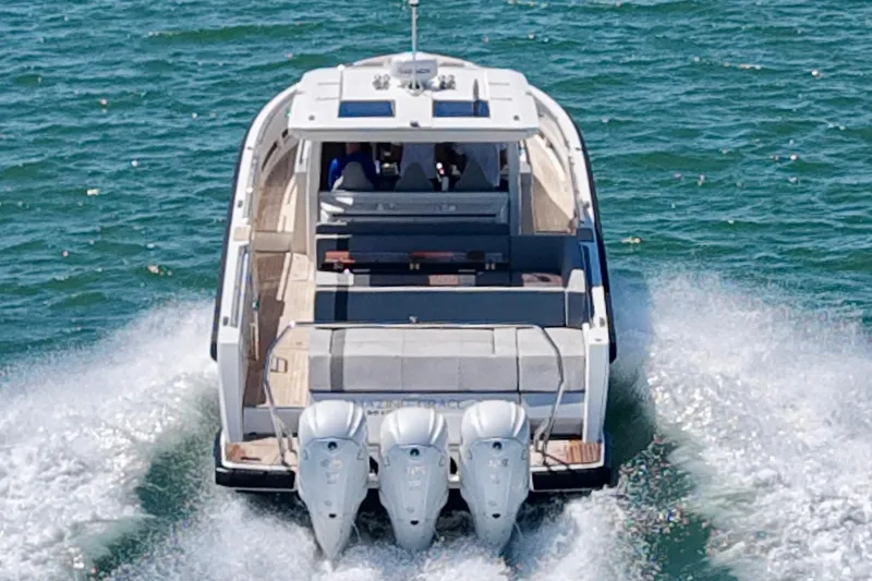 Slide: The Image of 2022 Windy SR 44 BLACKHAWK cruising on open water with triple outboard engines. - 5