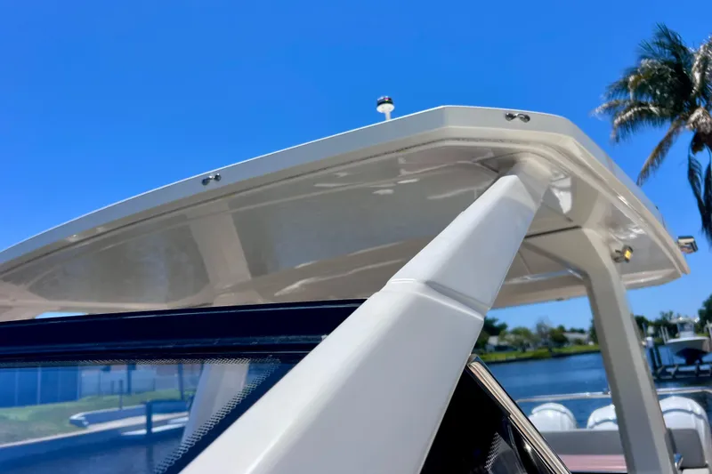Slide: The Image of 2022 Windy SR 44 BLACKHAWK boat detail against clear blue sky and palm trees. - 65