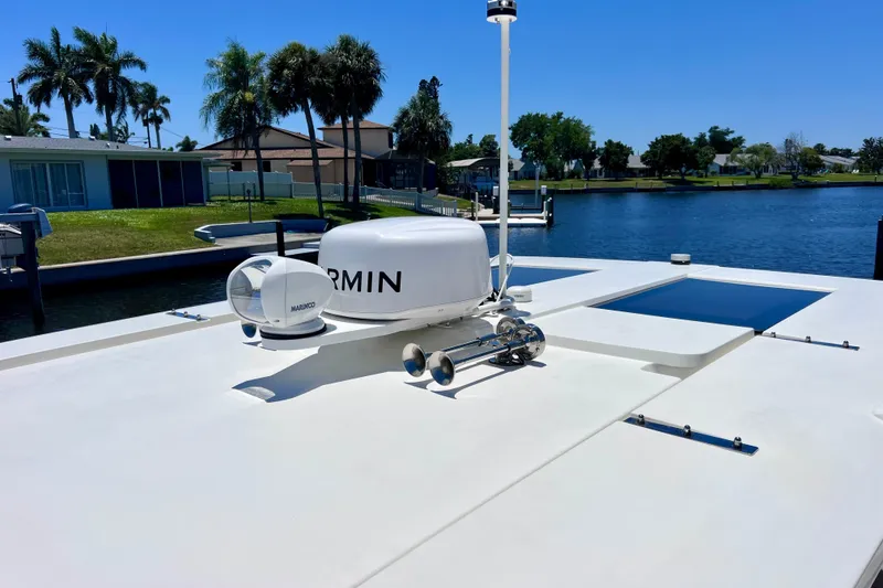 Slide: The Image of 2022 Windy SR 44 BLACKHAWK yacht with Garmin equipment, docked by a scenic waterfront. - 66