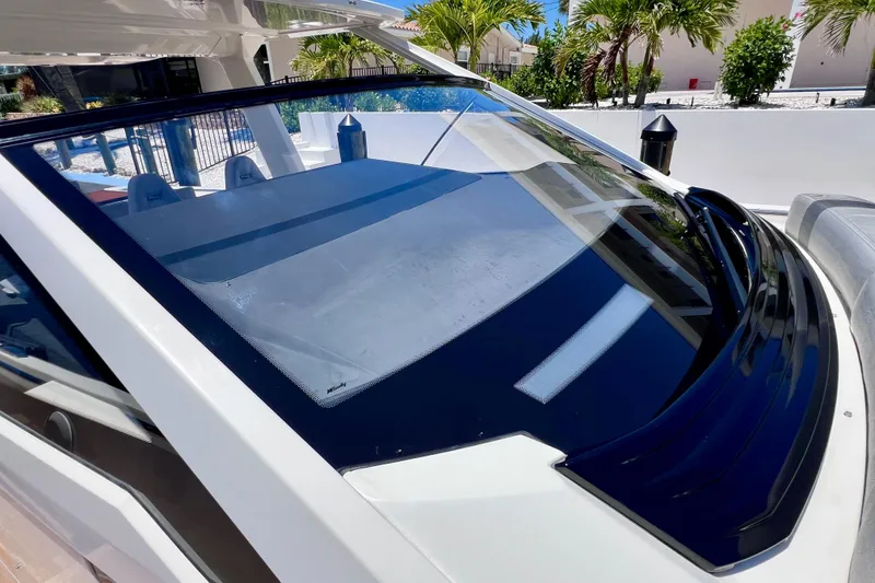 Slide: The Image of 2022 Windy SR 44 BLACKHAWK boat windshield, sleek design, tropical background. - 81