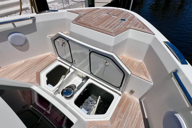 Slide: The Image of 2022 Windy SR 44 BLACKHAWK boat deck with open storage compartments and teak flooring. - 82