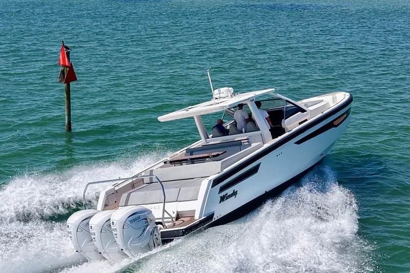 Slide: The Image of 2022 Windy SR 44 BLACKHAWK cruising on open water with triple Yamaha engines. - 9