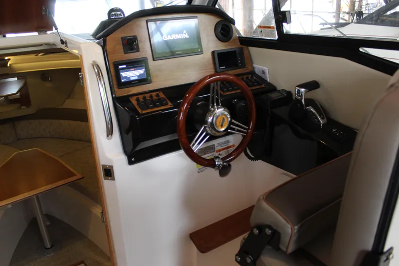Slide: The Image of 2024 Cutwater C-248 Coupe helm with Garmin navigation, wood accents, and comfortable seating. - 11