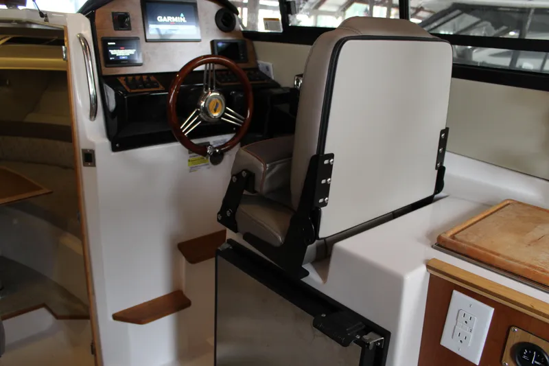 Slide: The Image of 2024 Cutwater C-248 Coupe interior with helm, steering wheel, and navigation system. - 12