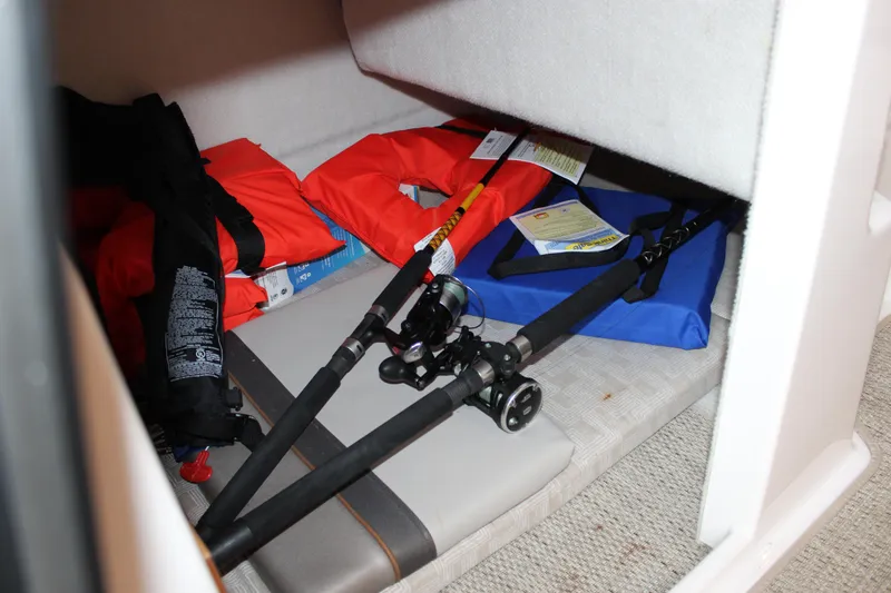 Slide: The Image of Storage area in 2024 Cutwater C-248 Coupe with fishing rods and life jackets. - 16