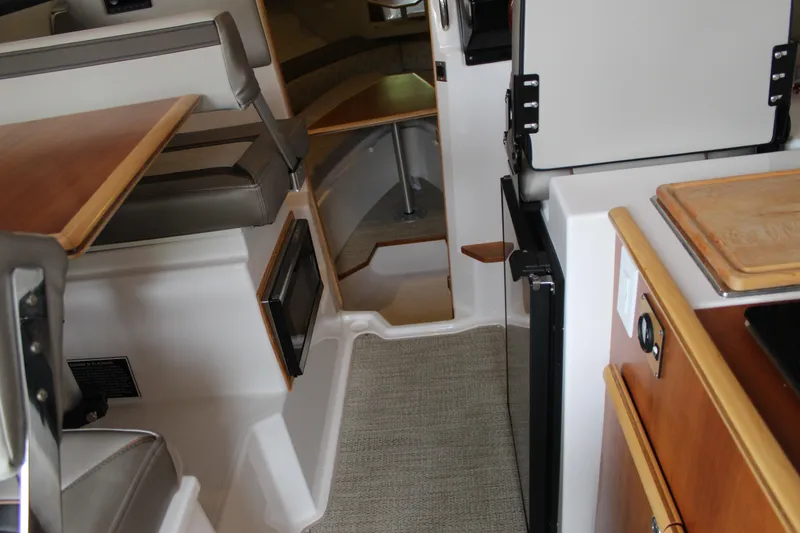Slide: The Image of 2024 Cutwater C-248 Coupe interior with seating, kitchenette, and cabin entry. - 20
