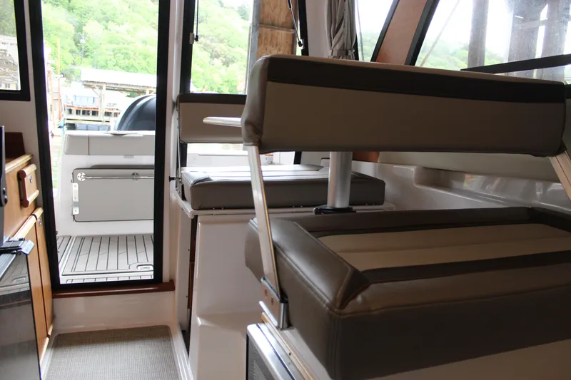 Slide: The Image of 2024 Cutwater C-248 Coupe interior with cushioned seating and open deck view. - 22