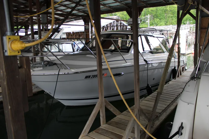 Slide: The Image of 2024 Cutwater C-248 Coupe docked in a covered marina. - 24