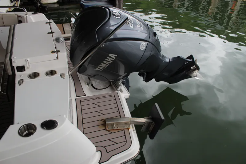 Slide: The Image of 2024 Cutwater C-248 Coupe with Yamaha outboard motor, docked on calm water. - 26