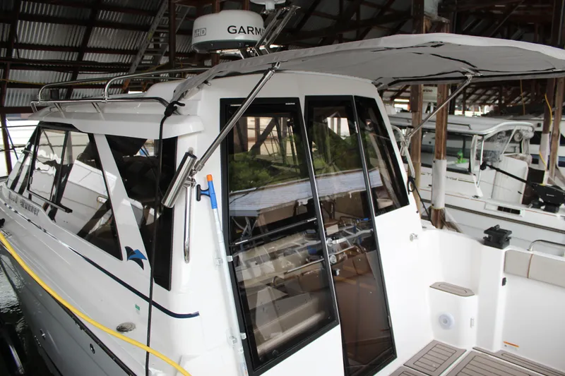 Slide: The Image of 2024 Cutwater C-248 Coupe boat docked in a marina, featuring sleek design and modern amenities. - 27