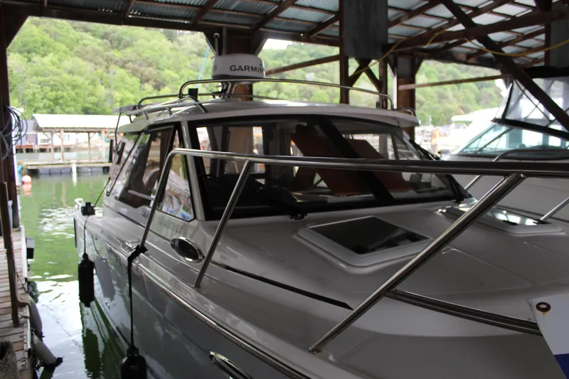 Slide: The Image of 2024 Cutwater C-248 Coupe docked in a marina under a covered structure. - 28