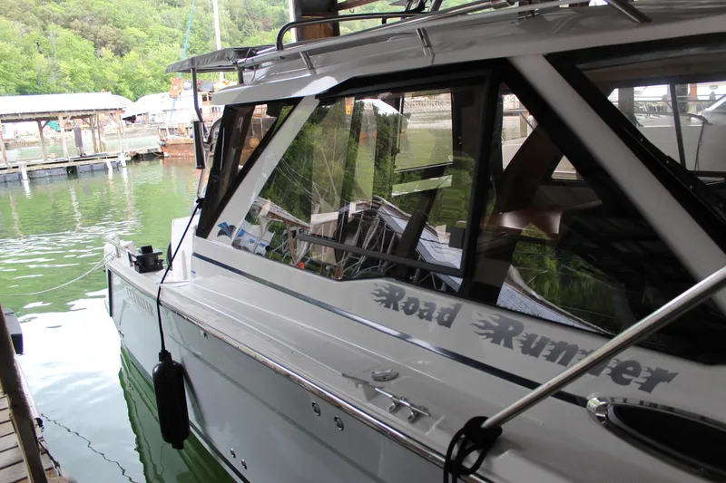 Slide: The Image of 2024 Cutwater C-248 Coupe docked, showcasing sleek design and reflective windows. - 29