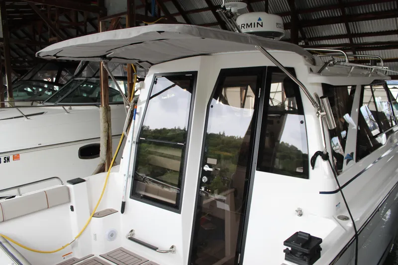 Slide: The Image of 2024 Cutwater C-248 Coupe boat docked in a covered marina. - 31