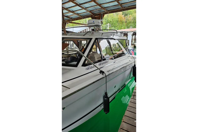 Slide: The Image of 2024 Cutwater C-248 Coupe docked under a covered marina, showcasing sleek design and modern features. - 4