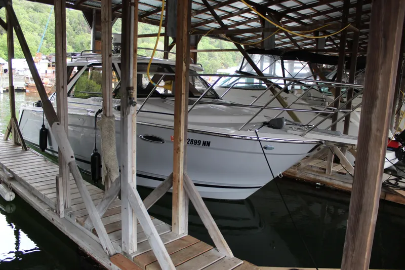 Slide: The Image of 2024 Cutwater C-248 Coupe docked in a covered marina. - 5