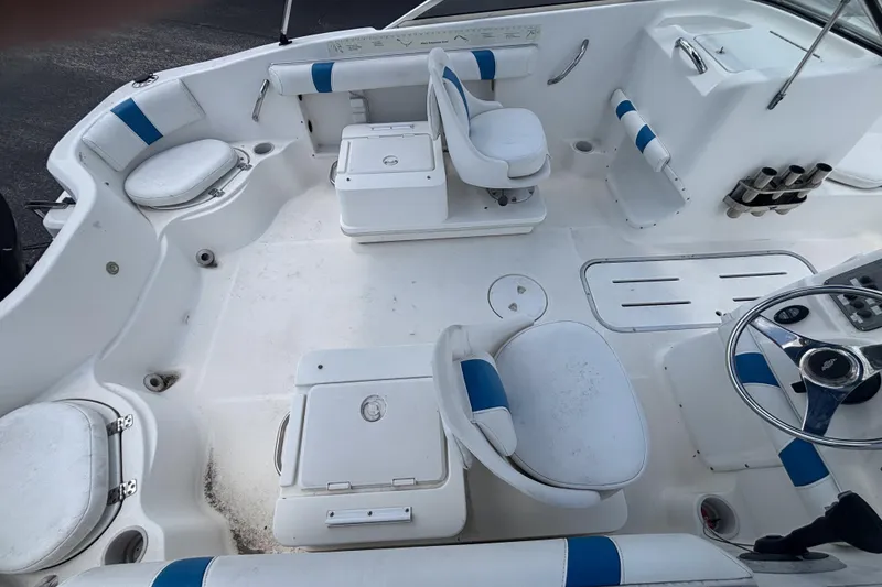 Slide: The Image of 2002 Wellcraft 180 Sportsman boat interior with white and blue seating and steering wheel. - 12