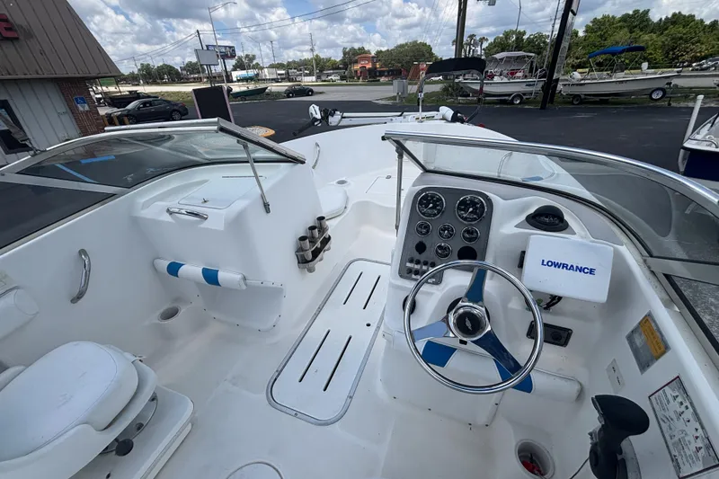 Slide: The Image of 2002 Wellcraft 180 Sportsman boat interior with steering wheel and navigation equipment. - 14